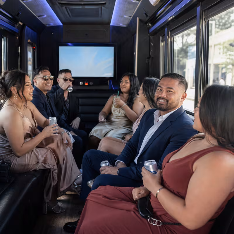 Wedding guests seated inside a Fontana party bus