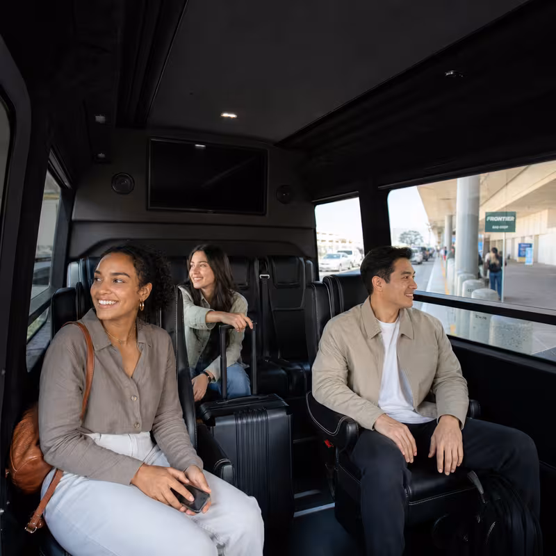 Passengers loading luggage while boarding an Fontana group shuttle