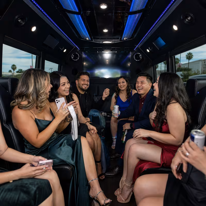 Party bus interior with wraparound leather seating and LED lighting in Fontana