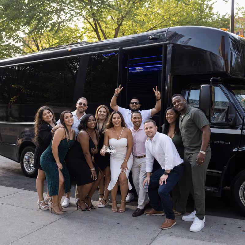 Party bus interior with wraparound leather seating and LED lighting in Fontana