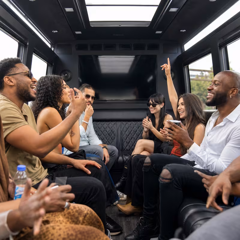 Group boarding a white charter bus for Concert Transportation transportation in Fontana