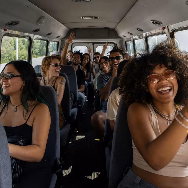 Party bus interior with wraparound leather seating and LED lighting in Fontana