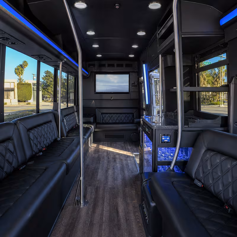 Party bus interior with wraparound leather seating and LED lighting in Fontana
