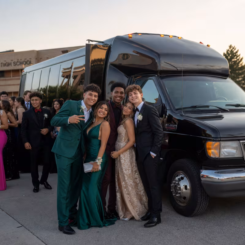 Group boarding a white charter bus for Prom & Homecoming Transportation transportation in Fontana