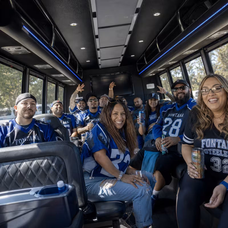 Group boarding a white charter bus for Sporting Event Transportation transportation in Fontana