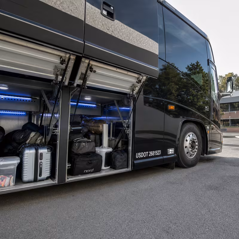 Party bus interior with wraparound leather seating and LED lighting in Fontana
