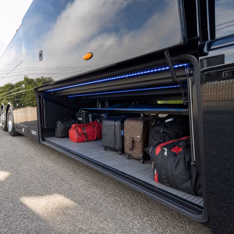 Party bus interior with wraparound leather seating and LED lighting in Fontana