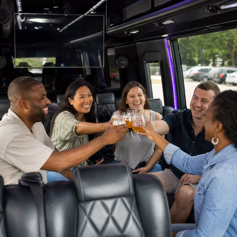Group boarding a white charter bus for Winery & Brewery Tour Transportation transportation in Fontana
