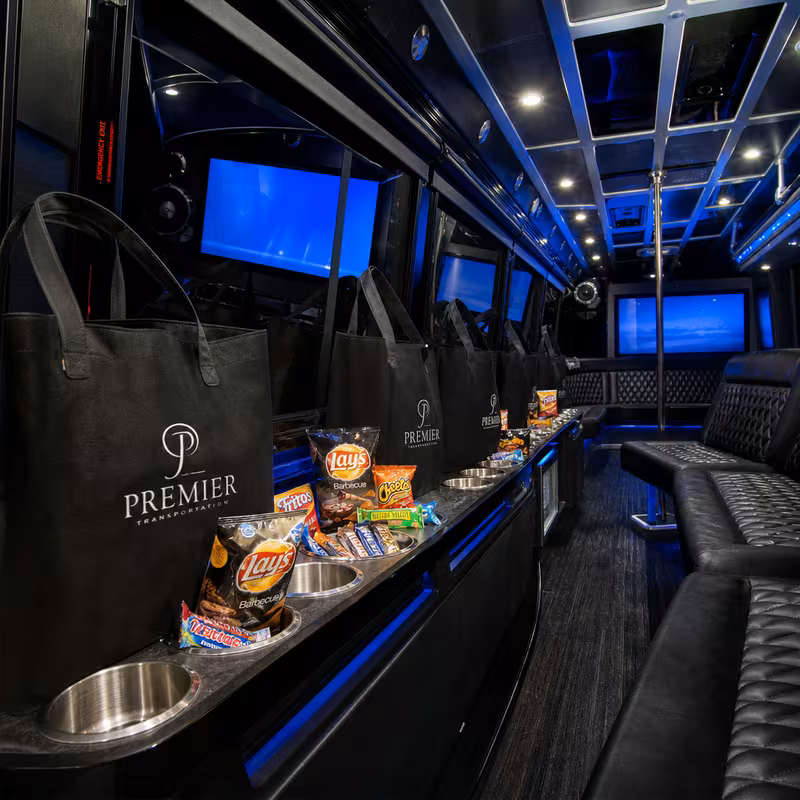 Party bus interior with wraparound leather seating and LED lighting in Fontana